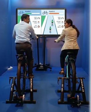 Interactive cycling game with leaderboard at a corporate fitness event